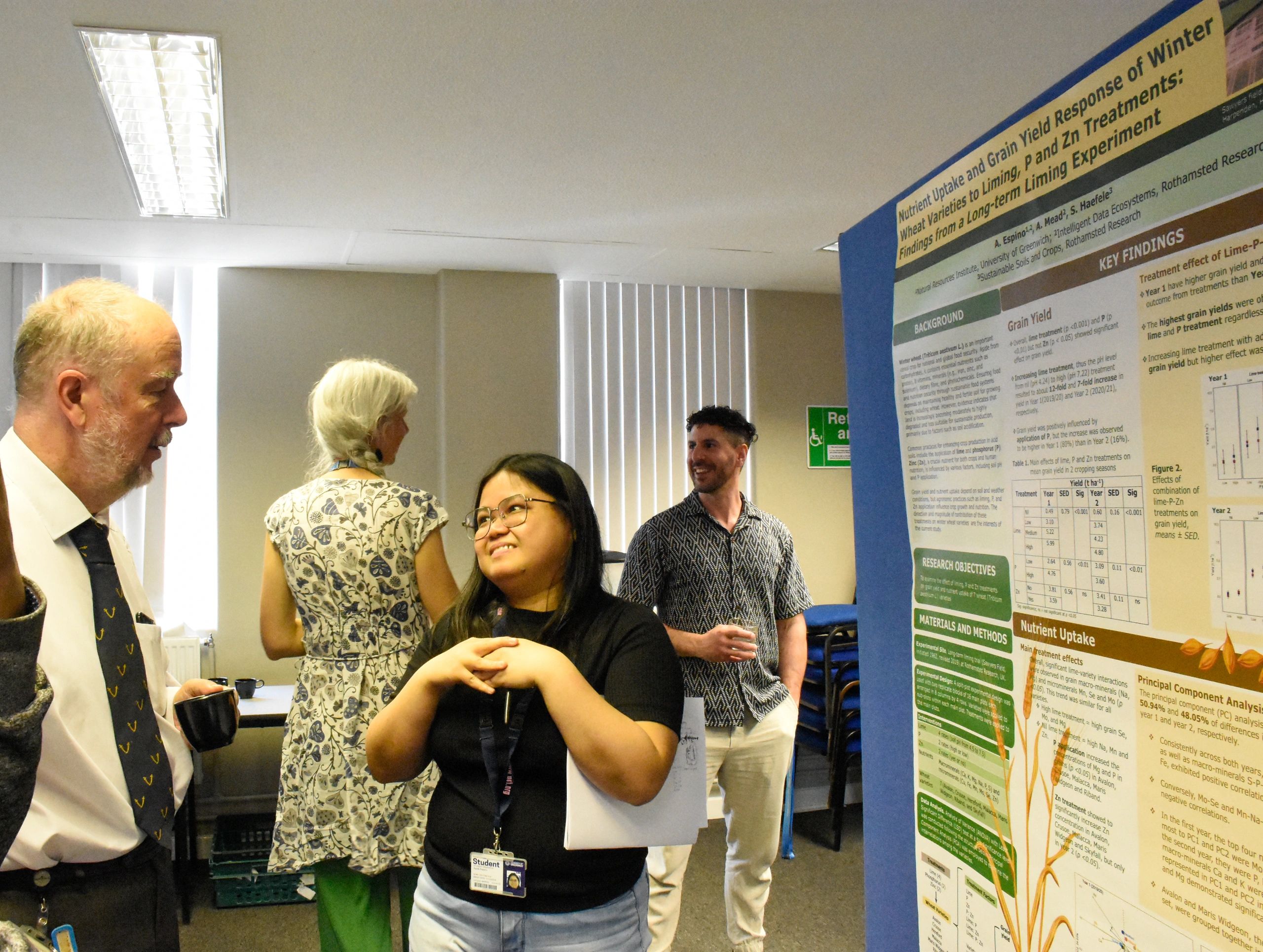 Alexandros discussing a research poster at a conference