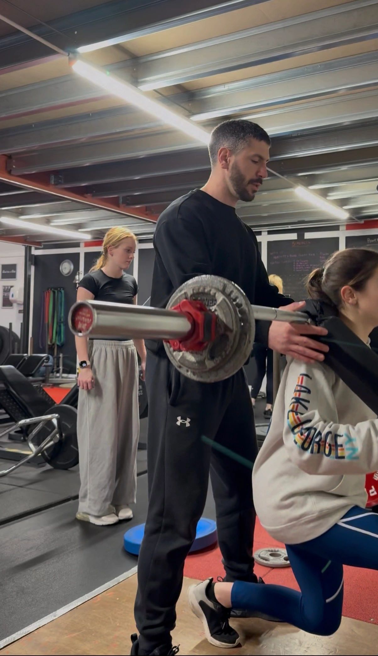 Alexandros supervising a client during strength training