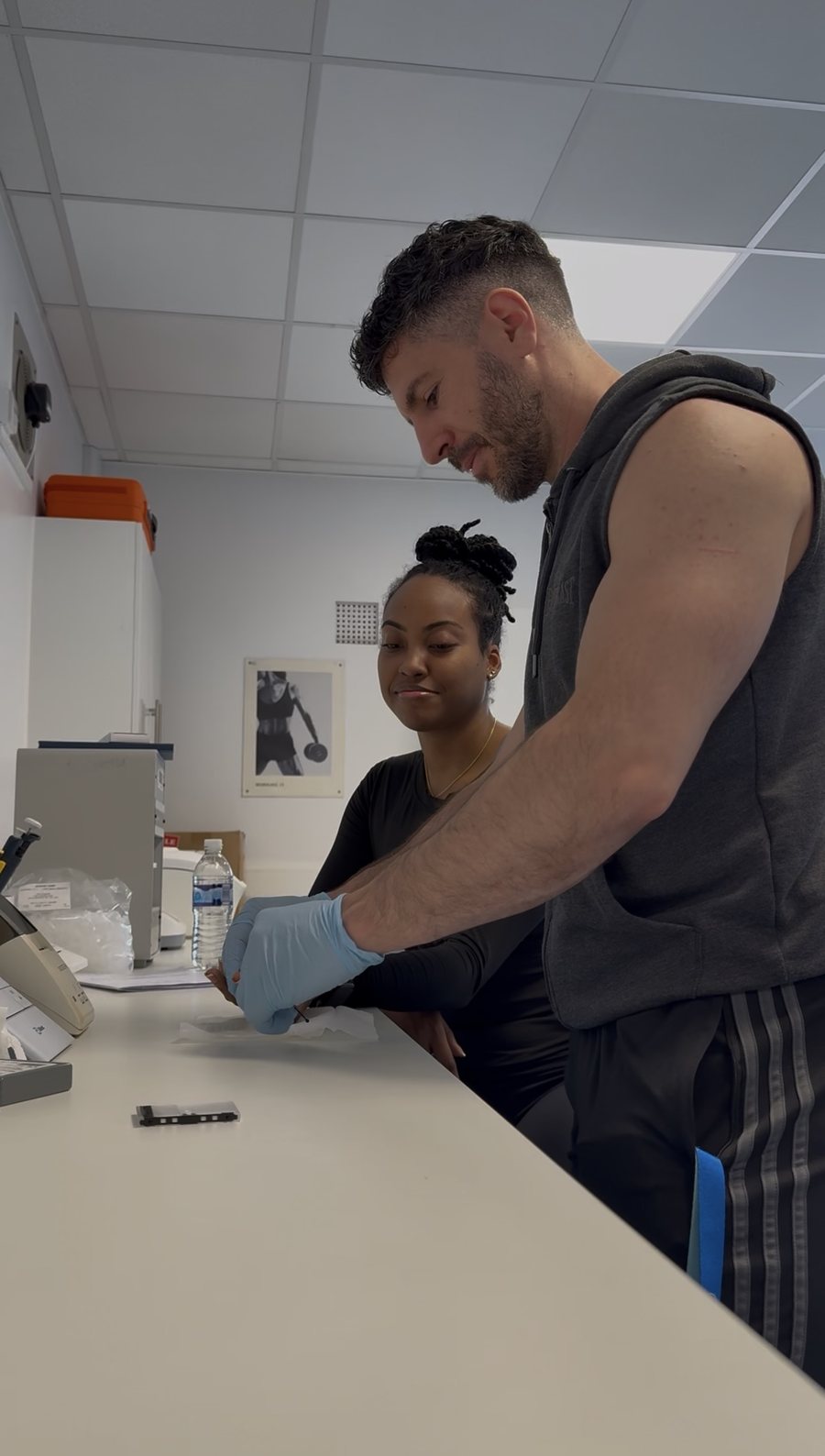 Alexandros running a finger-prick blood test with a client