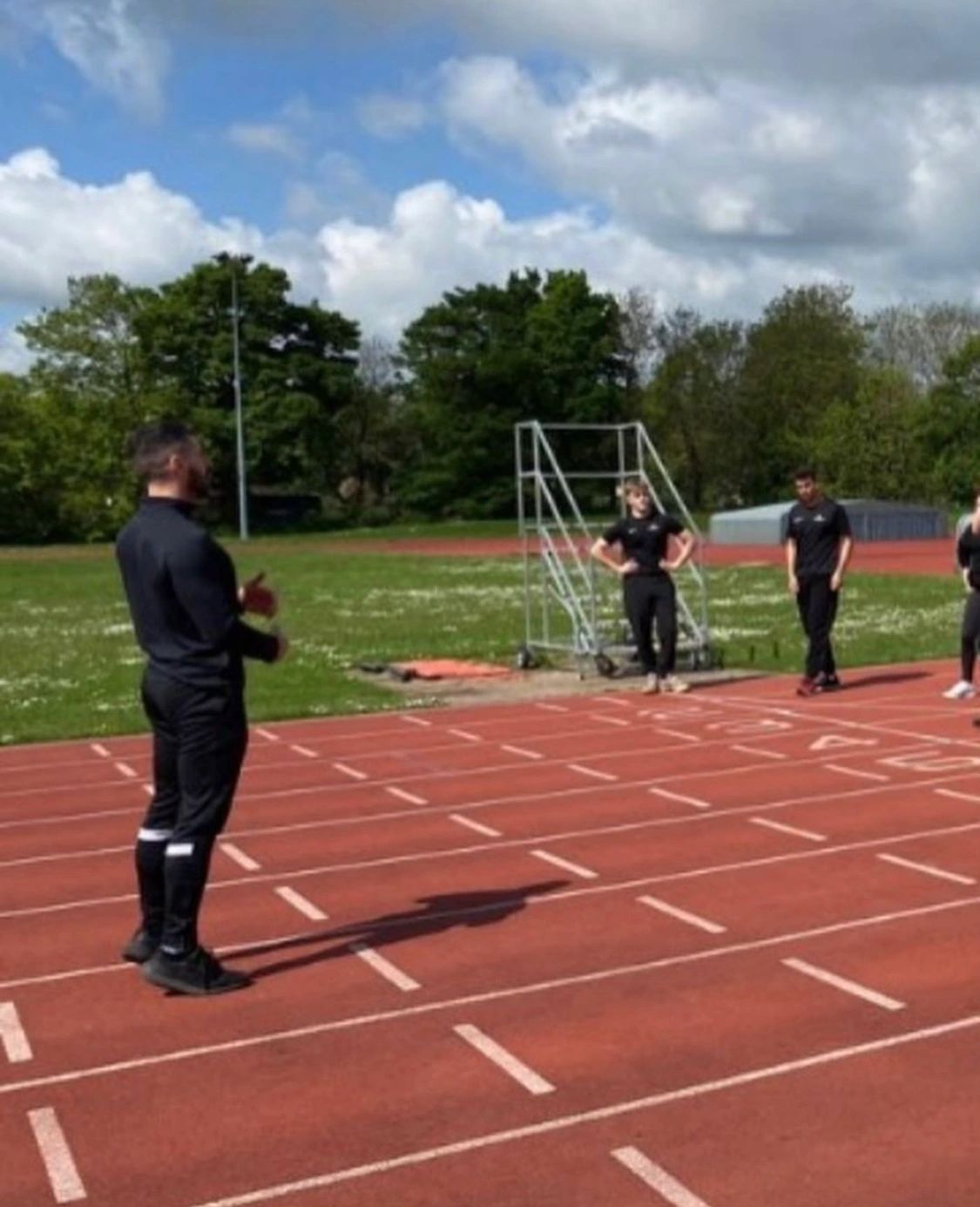 Alexandros coaching on an athletics track